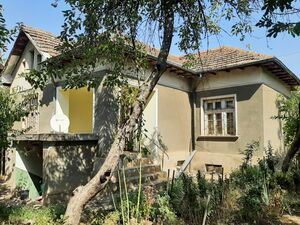 Country house with yard and many outbuildings in a village